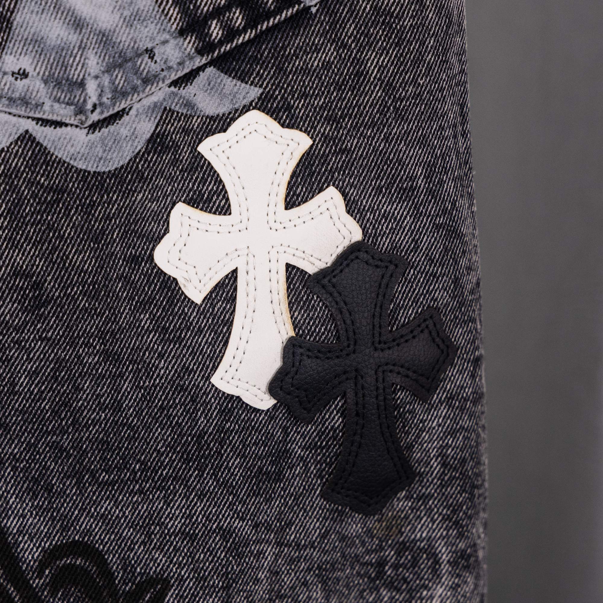 Denim close-up with white and black cross patches