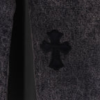 Denim fabric close-up with black cross patch