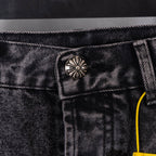 Dark denim pants waistband with decorative button detail and stitched belt loops