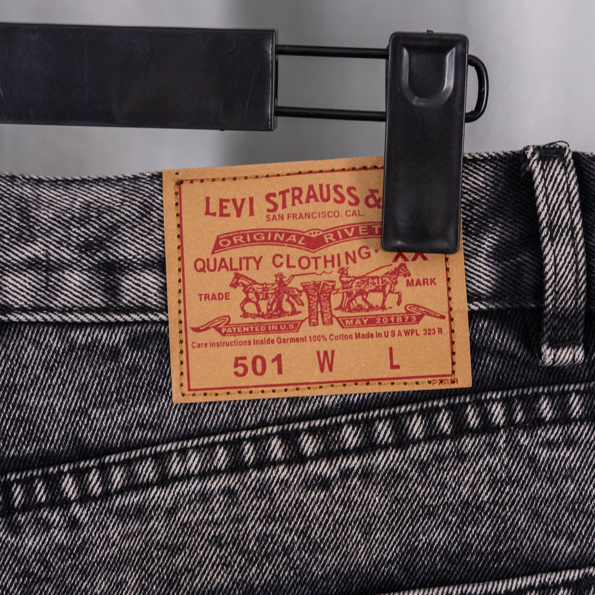 Dark denim pants with Levi Strauss & Co. 501 label near waistband