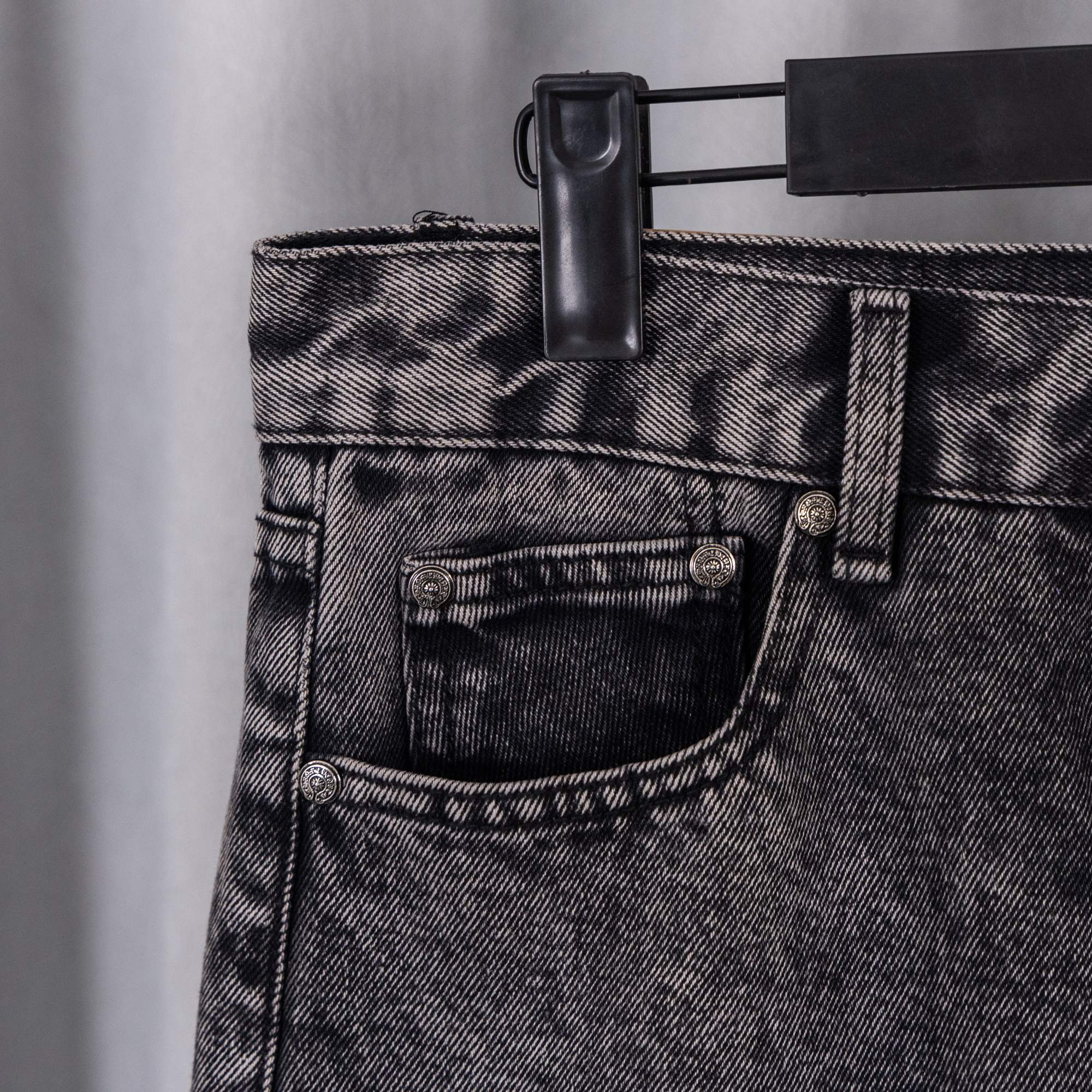 Dark denim pants front pocket with rivet button and stitched waistband
