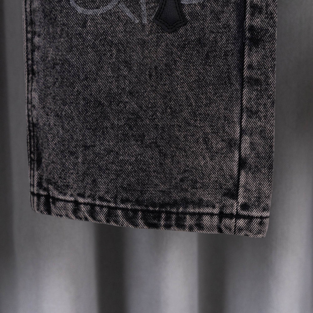 Dark wash denim pants hem detail with stitched cuff