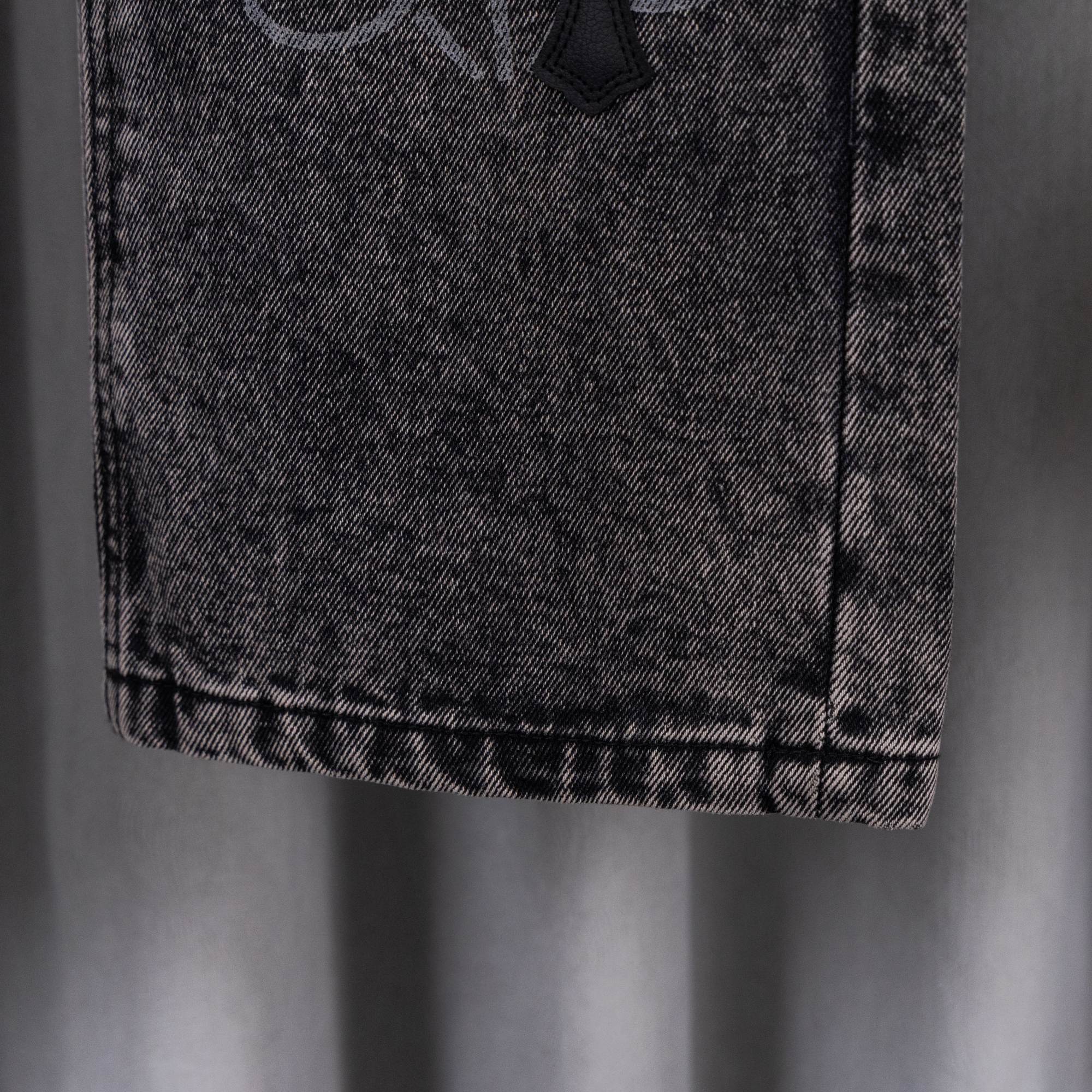 Dark wash denim pants hem detail with stitched cuff