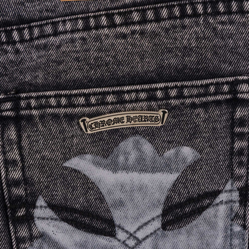 Dark denim pants back pocket with large cross artwork