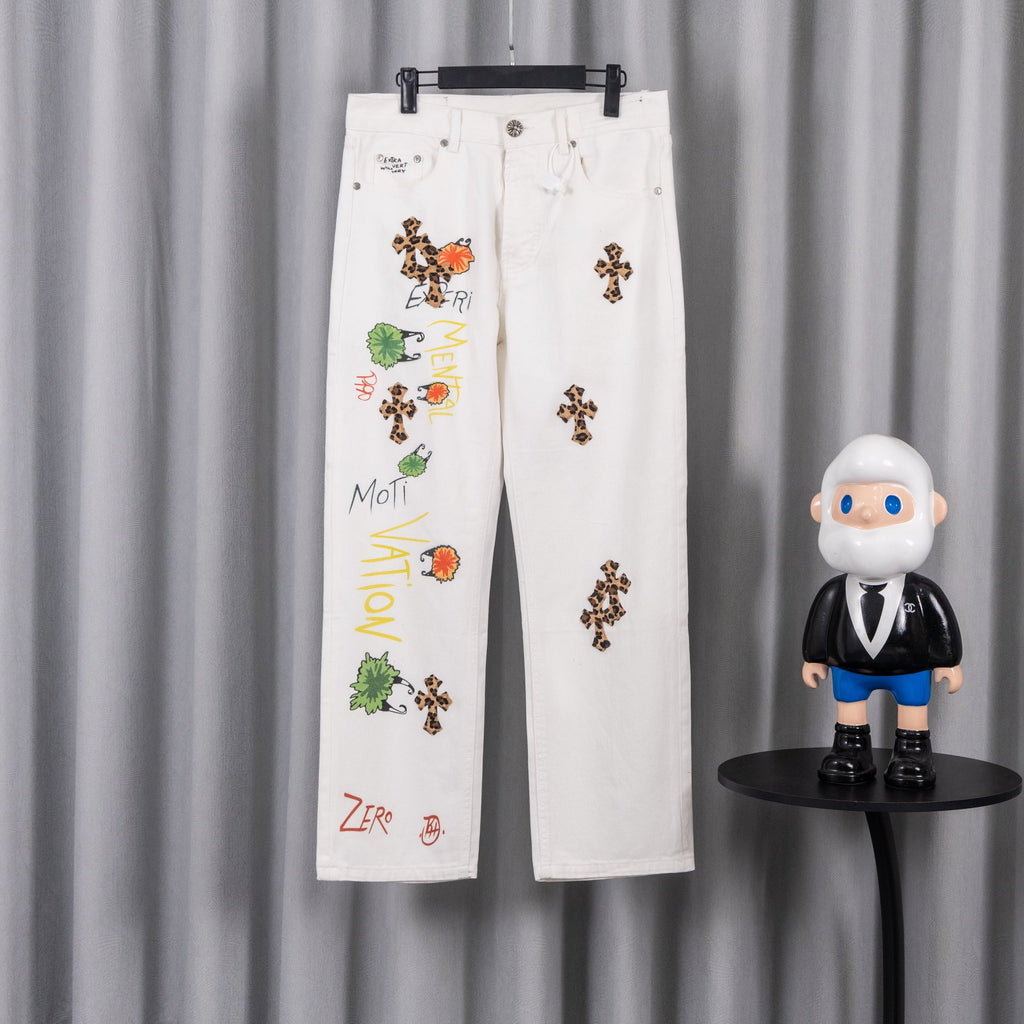 White pants with colorful cross graphic and small leopard-print patches