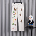 White pants with colorful cross graphic and small leopard-print patches