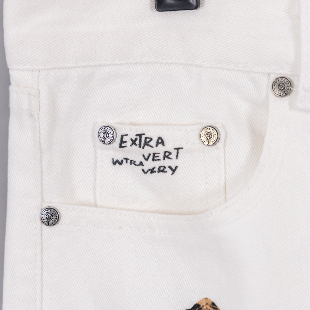White pants with “Extra Vert Very” label and round button details