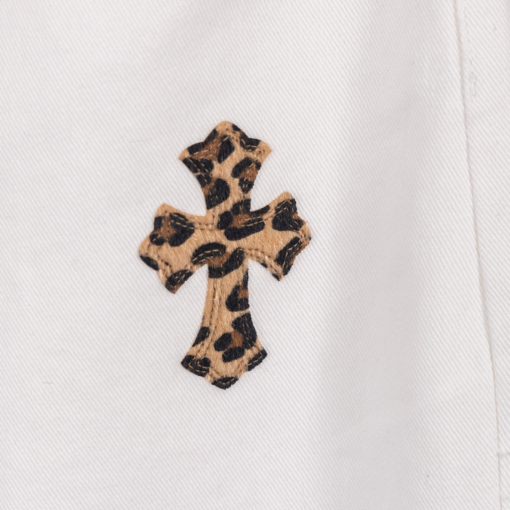 White pants with small leopard-print cross patch on the leg