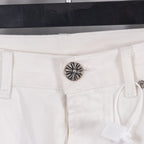 White pants with metal button and “Extra Vert Very” label on waistband