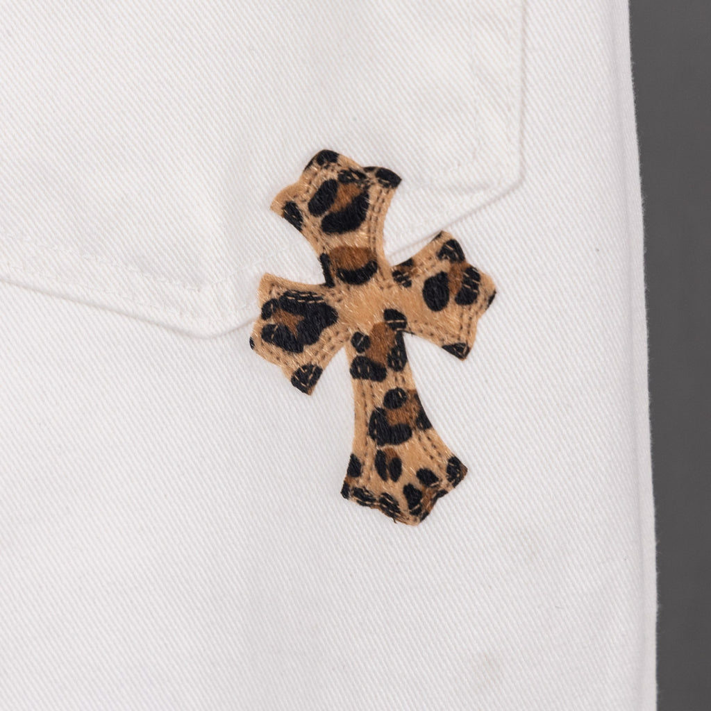 White pants with small leopard-print cross patch on the leg