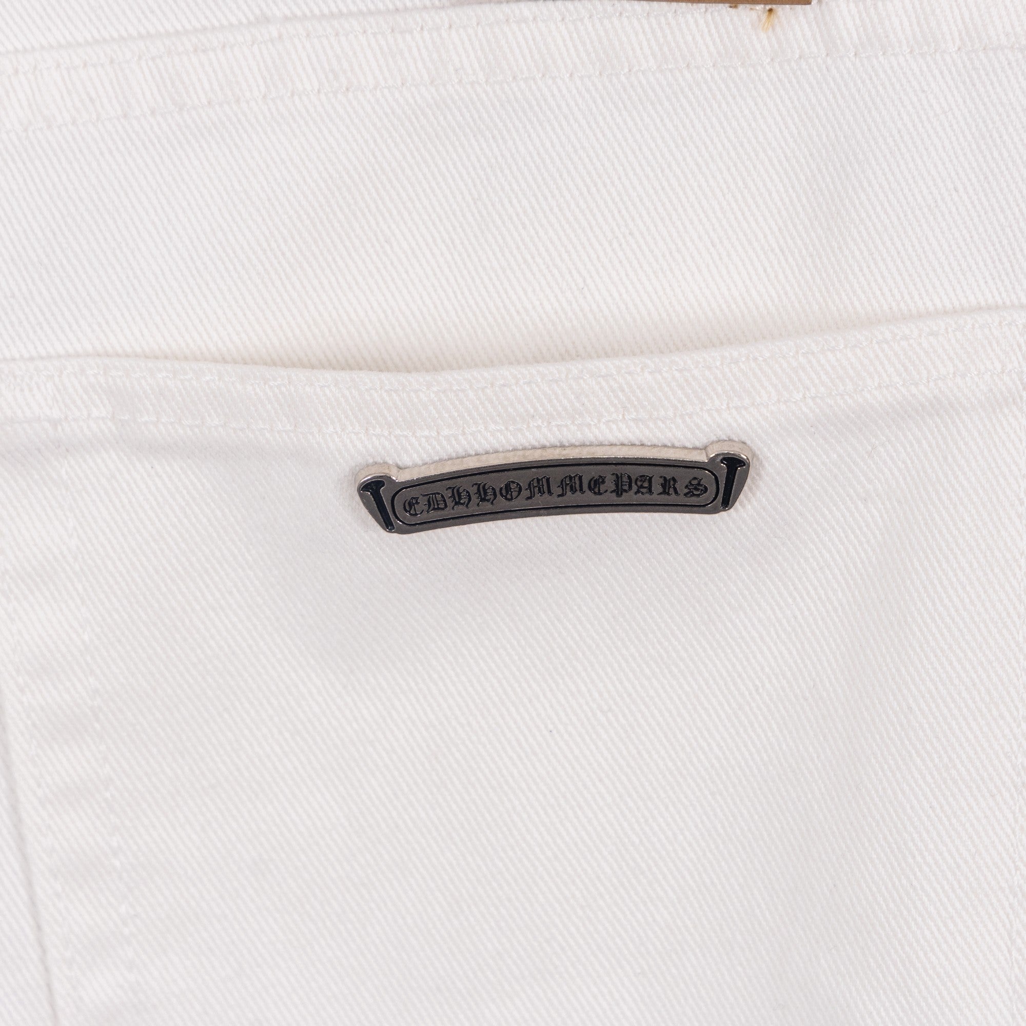 White denim pants with metal brand tab on front pocket