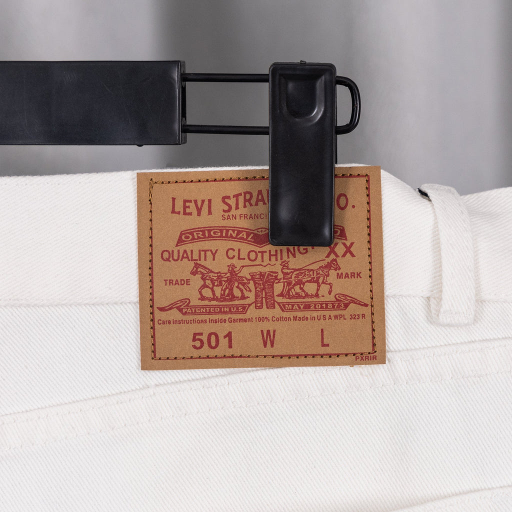 White denim pants with Levi Strauss size label at waistband
