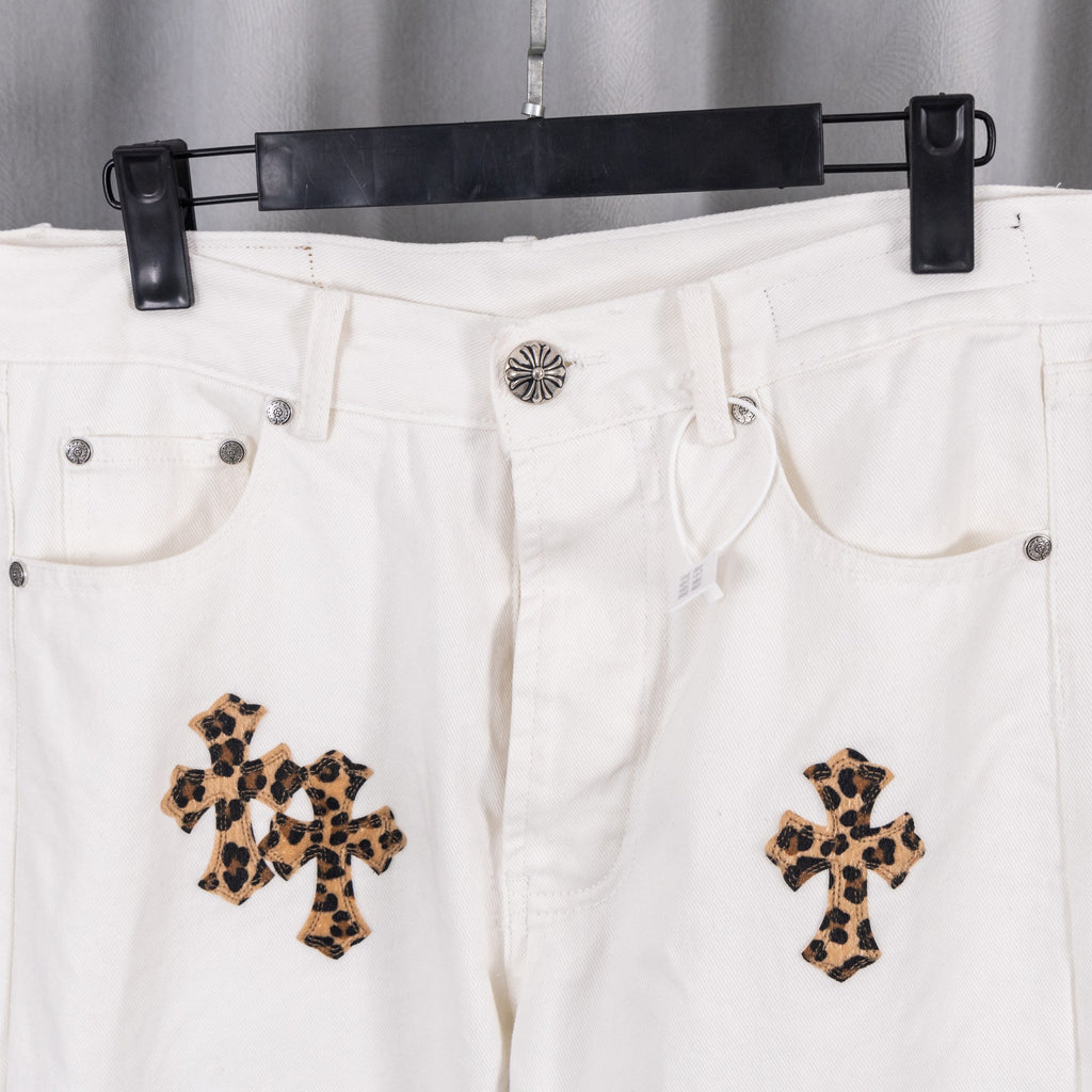 White denim pants waistband with metal button and leopard-print cross patches