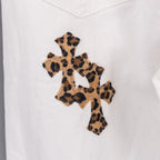 Leopard-print cross patch on white denim pants