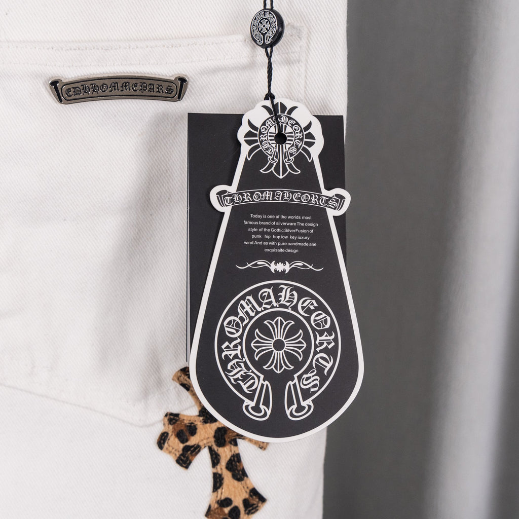 White denim pants with decorative hangtag and leopard-print cross patch