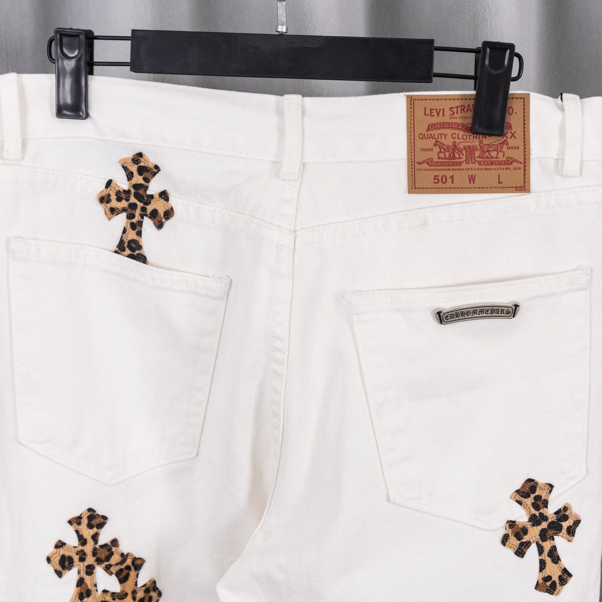 White denim pants back view with pockets and leopard-print cross patches