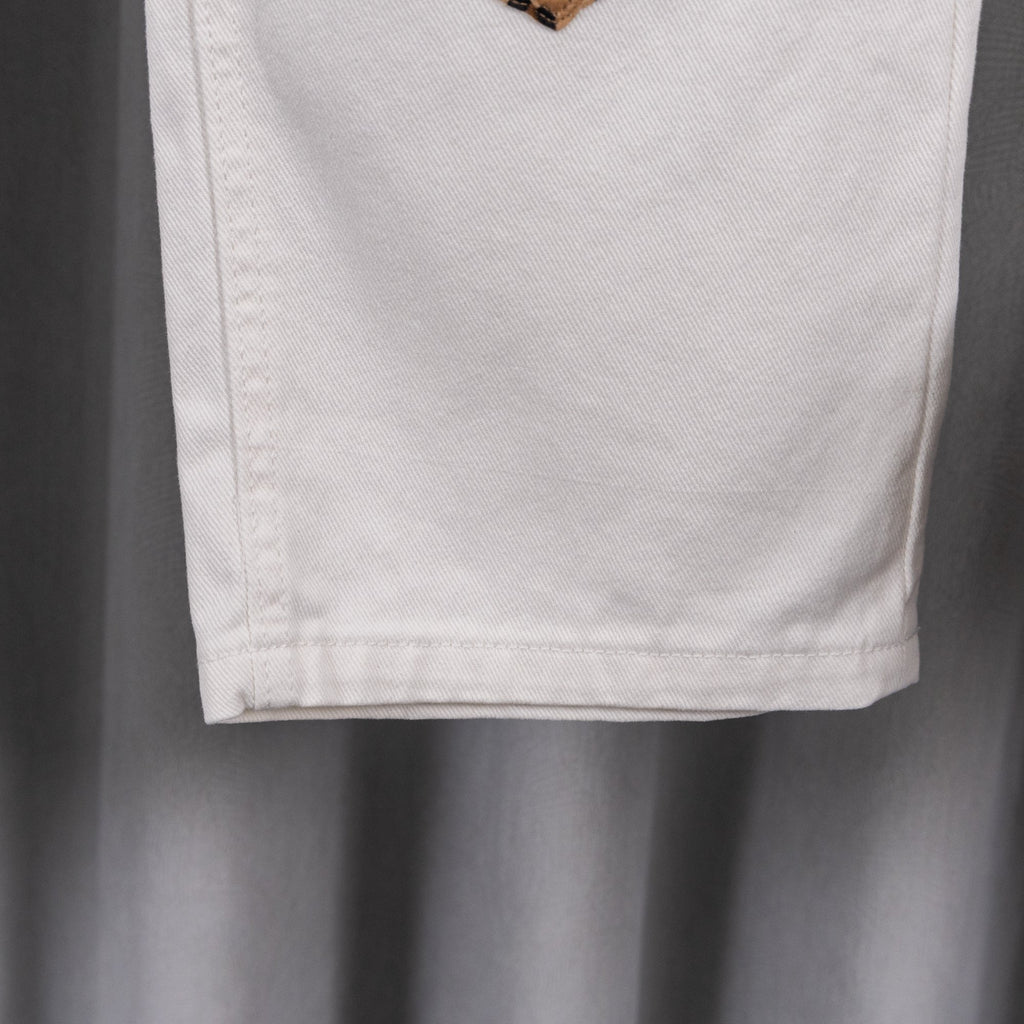 White denim pants hem and side seam