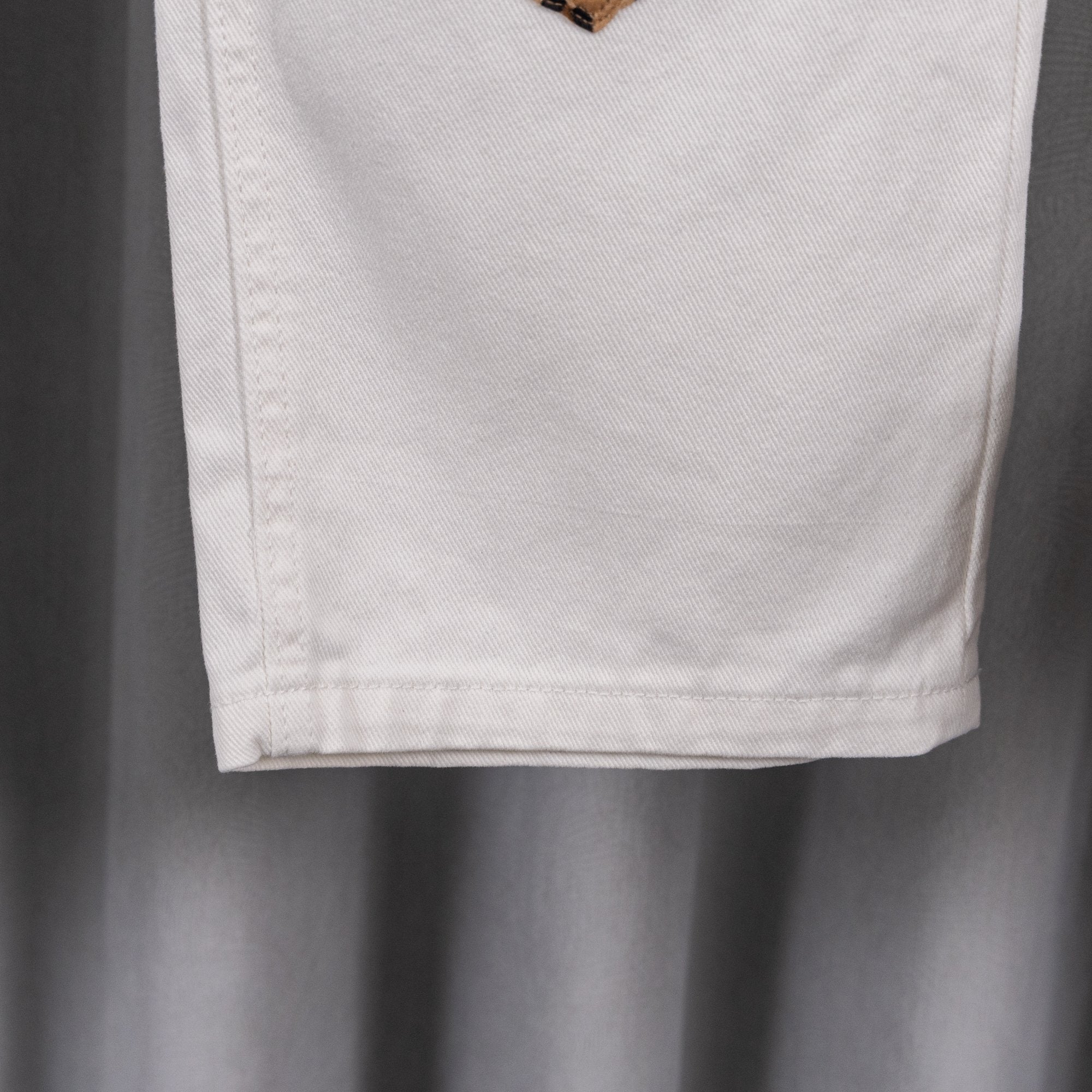 White denim pants hem and side seam