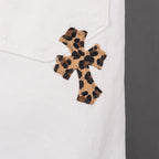 White pants with leopard-print cross appliqué on leg