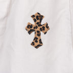 White pants with leopard-print cross appliqué on front