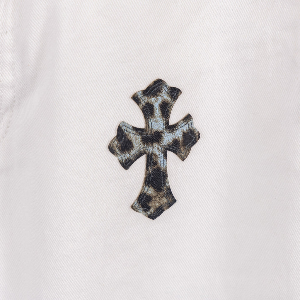 Orange and black cross applique on white denim pants