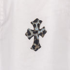 Orange and black cross applique on white denim pants