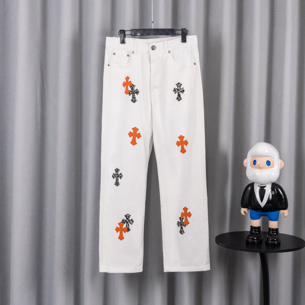 White denim pants with orange and black cross print, button-and-zip closure