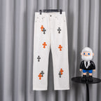 White denim pants with orange and black cross print, button-and-zip closure