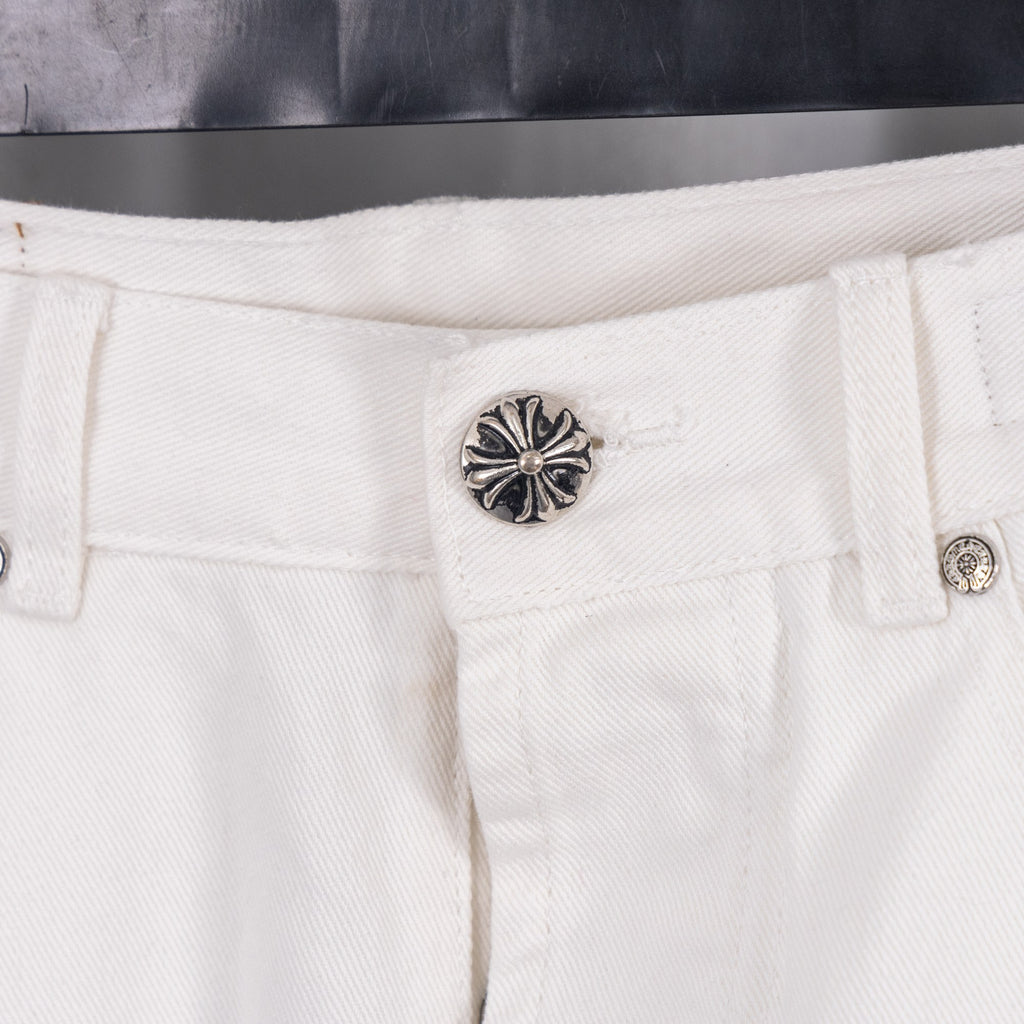 White denim pants with ornate silver button on the waistband