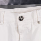 White denim pants with ornate silver button on the waistband