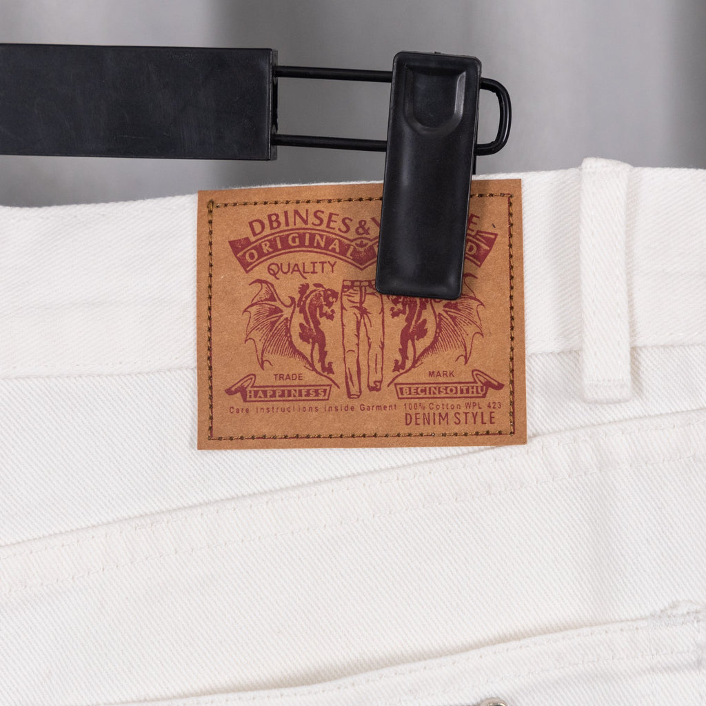 White denim pants with brown leather waistband label