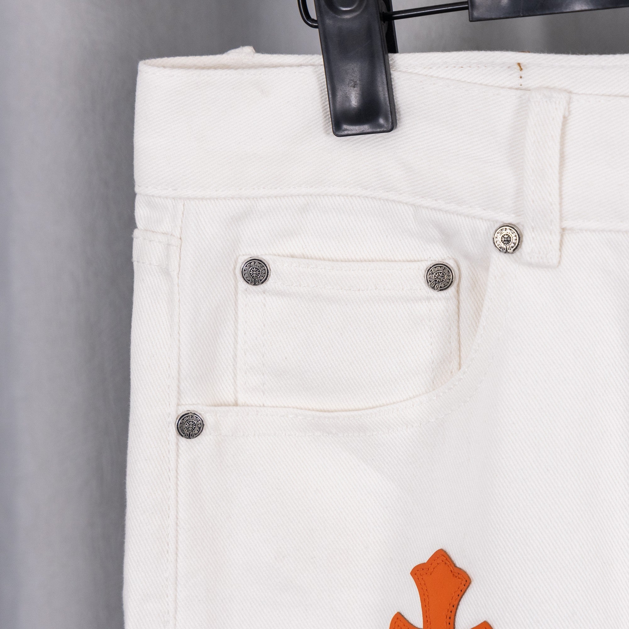 White chrome pants with button waistband and front jeans-style pockets