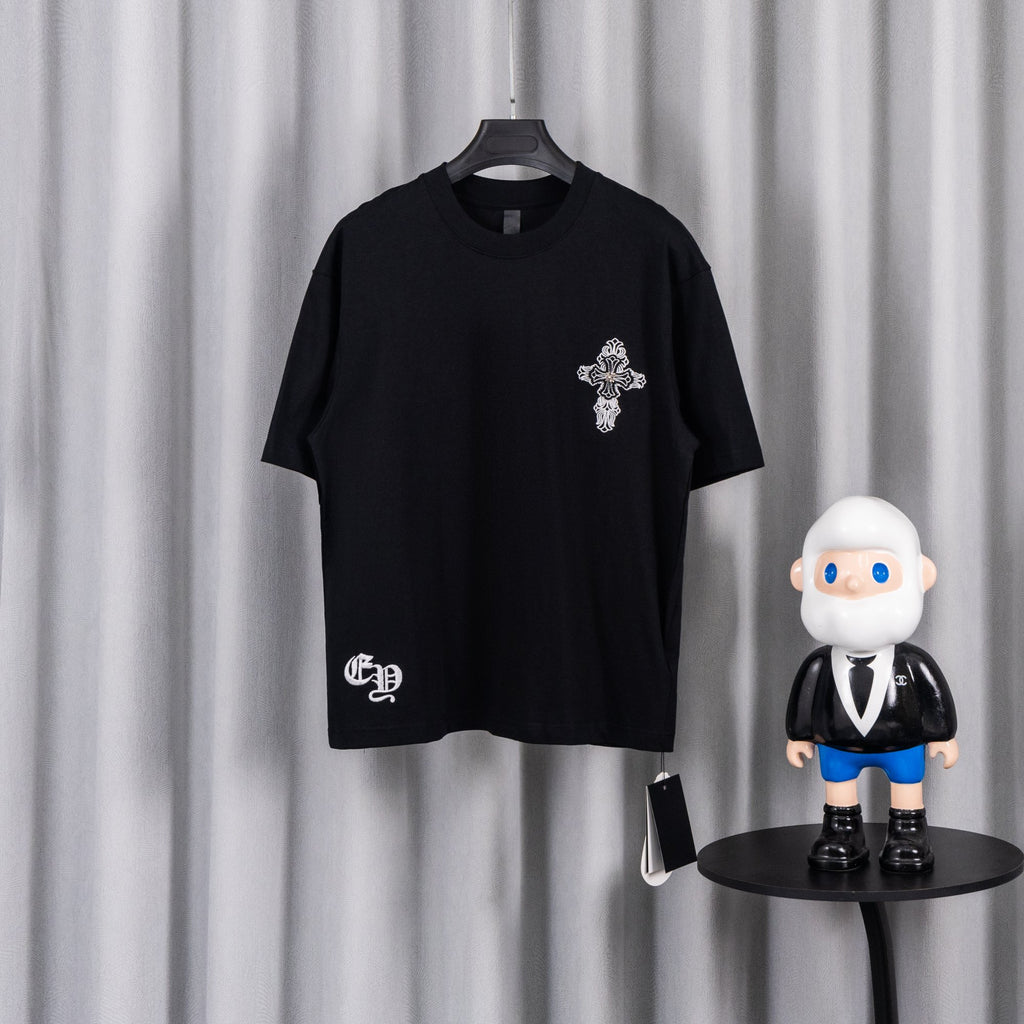 Black short-sleeve graphic T-shirt with small cross emblem on the chest