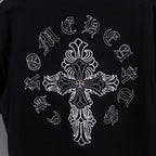 Black short-sleeve T-shirt with large white cross graphic and ornate floral details
