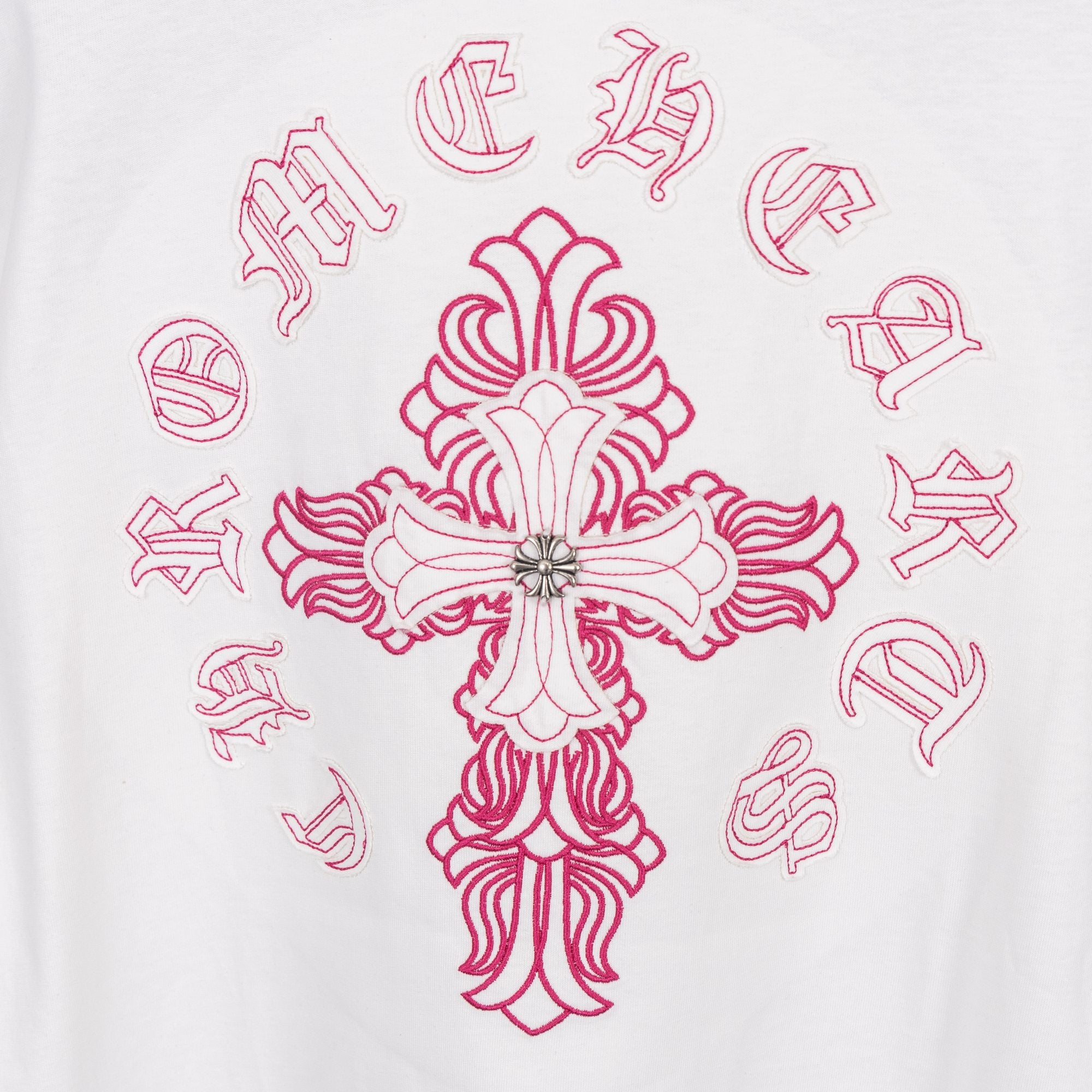 White T-shirt with large pink cross embroidery and surrounding symbols