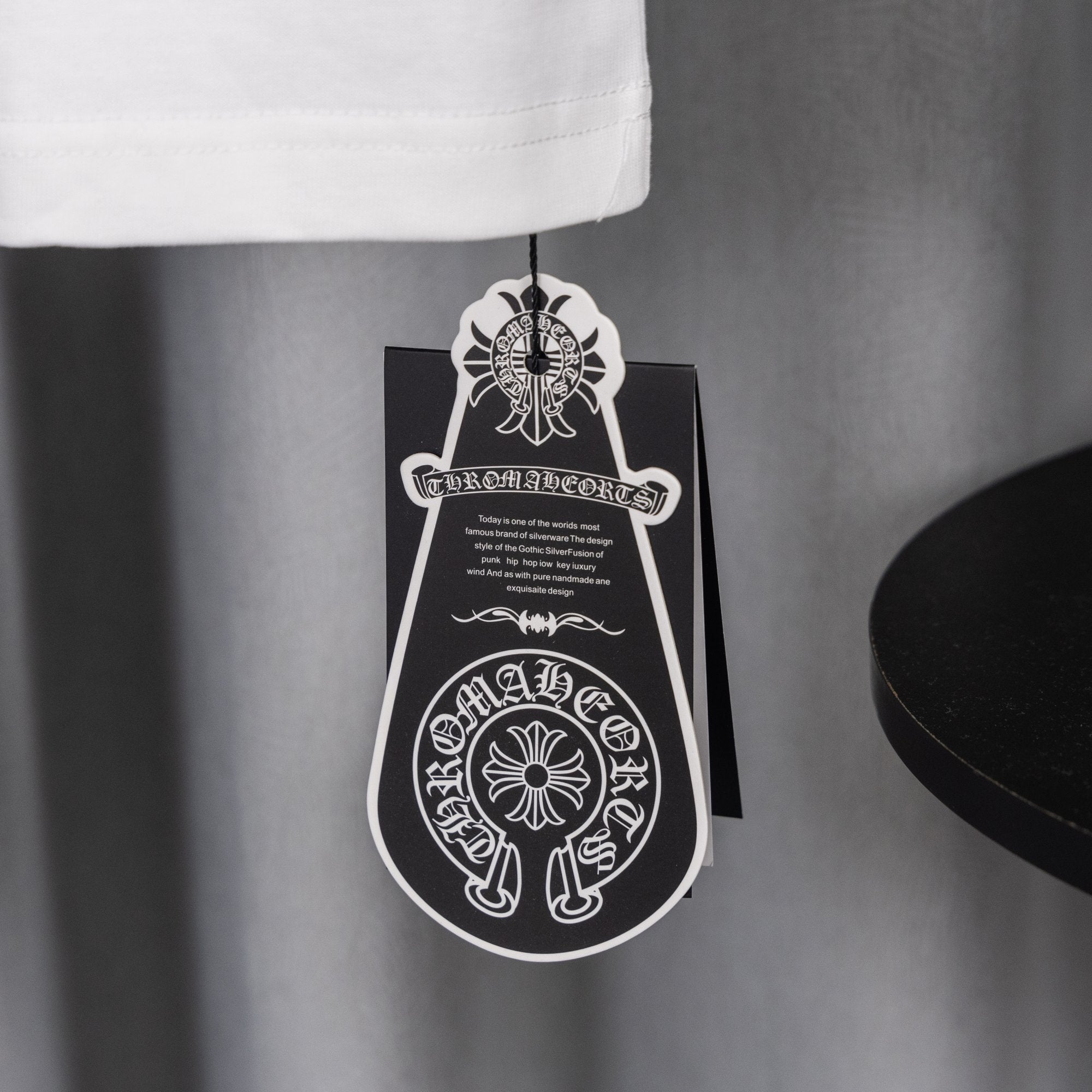 White T-shirt sleeve hem with hanging black-and-white hang tag