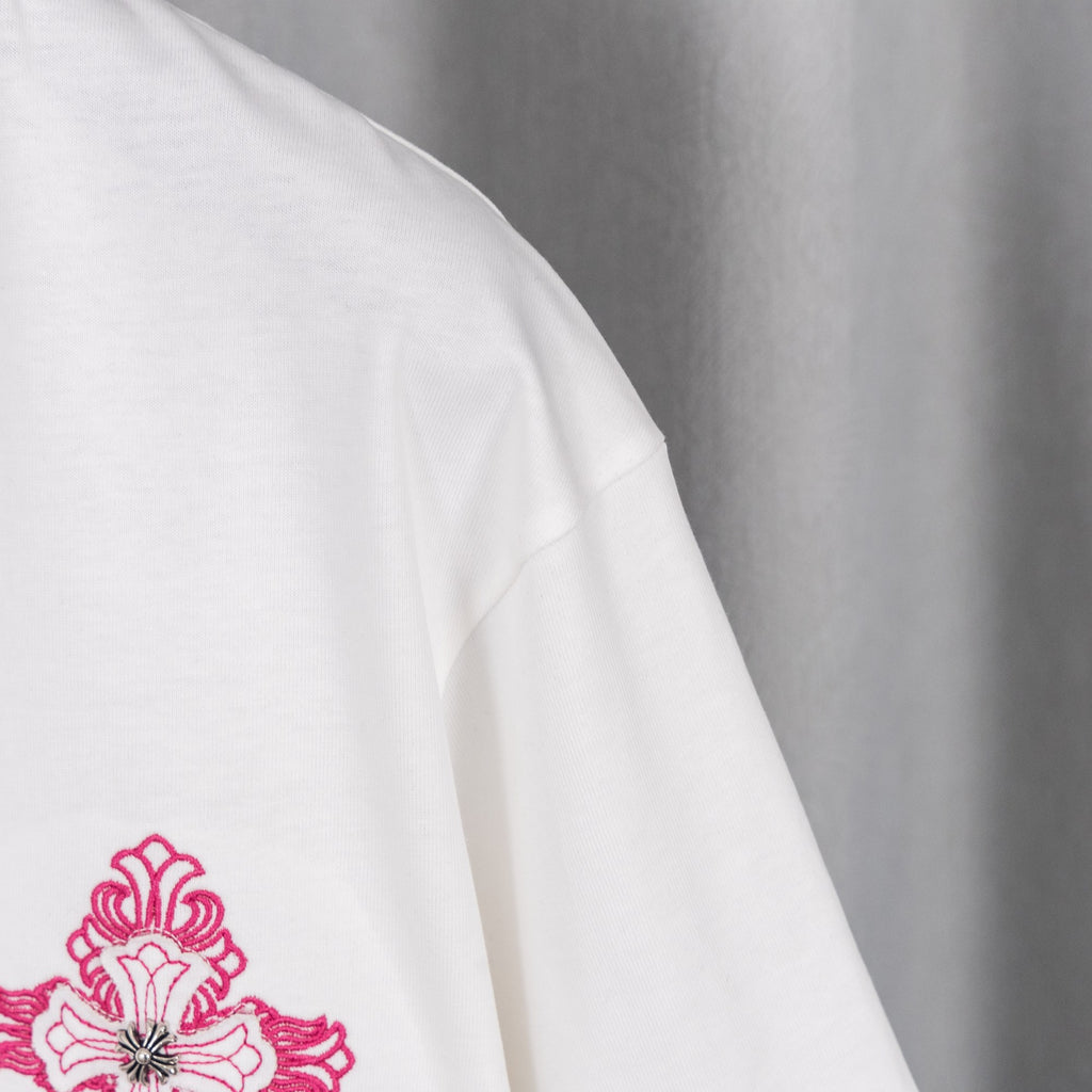 White T-shirt sleeve with magenta floral logo embroidery