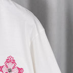 White T-shirt sleeve with magenta floral logo embroidery