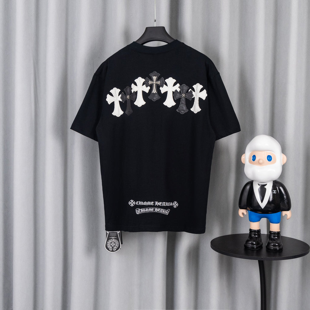 Black T-shirt back with row of white and gray cross appliques.