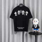 Black T-shirt back with row of white and gray cross appliques.