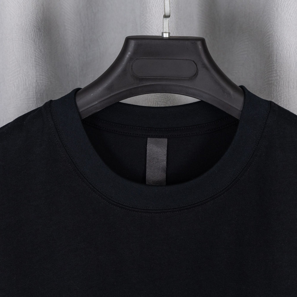 Black crewneck T-shirt neckline with central facing seam.