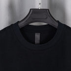 Black crewneck T-shirt neckline with central facing seam.