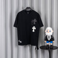Black short-sleeve T-shirt with white and gray cross chest appliques.
