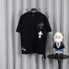 Black short-sleeve T-shirt with white and gray cross chest appliques.