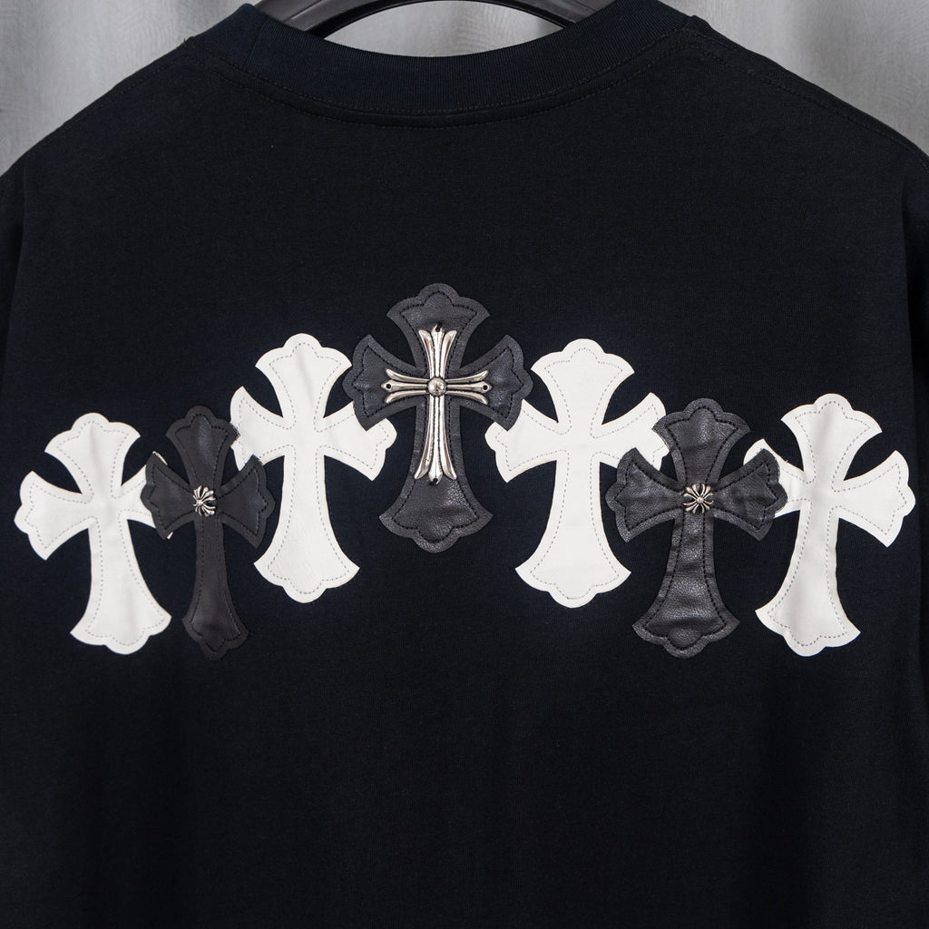 Black T-shirt with large white and gray cross applique on upper back.
