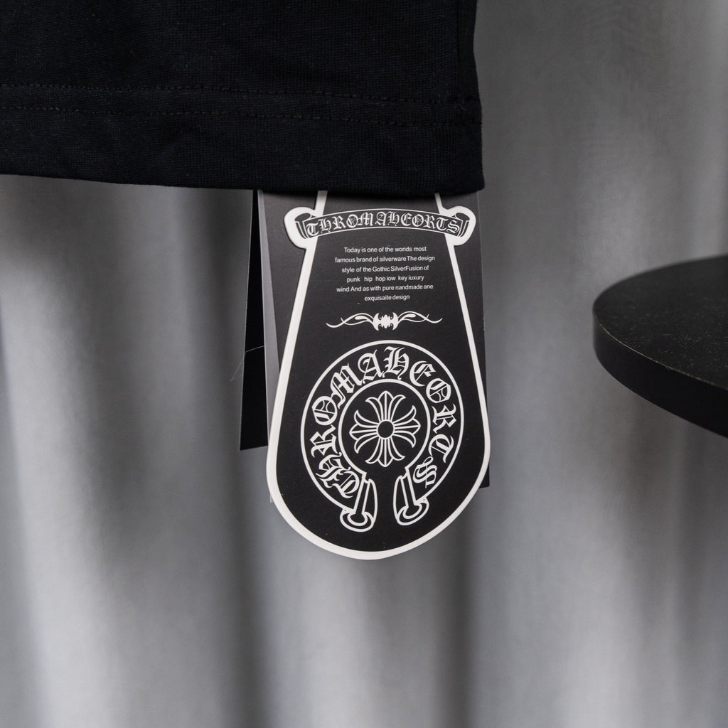Black garment tag hanging from T-shirt hem.