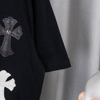 Black short-sleeve T-shirt with cross applique on sleeve.