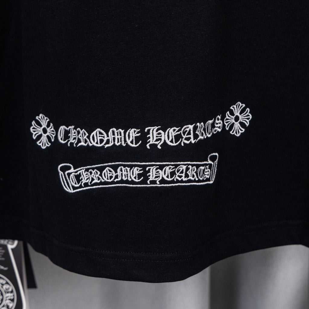Black short-sleeve shirt with white embroidered emblem and banner text