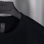 Black short-sleeve shirt neckline with woven label detail