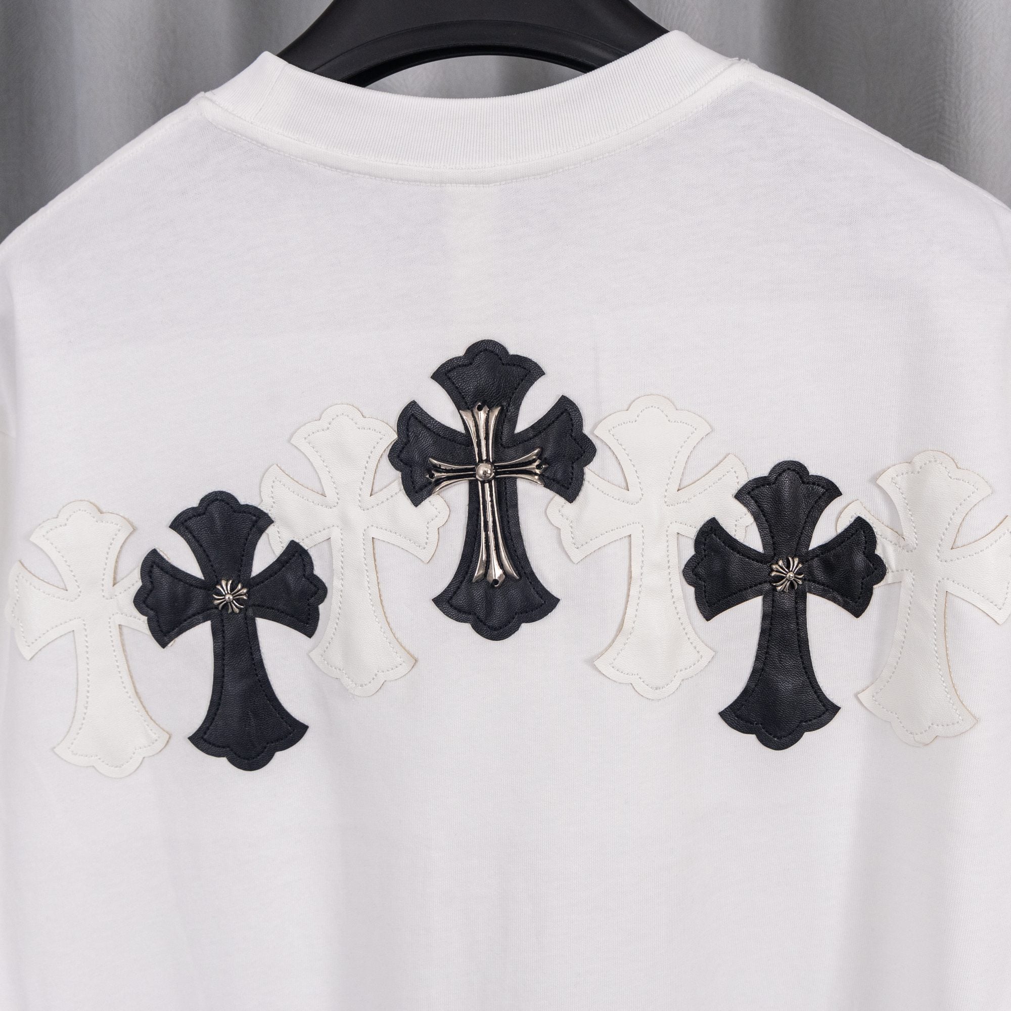 White T-shirt back with central black cross applique and three cross motifs